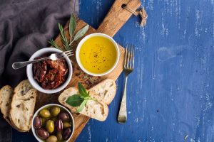 Mediterranean snacks set. Olives, oil, herbs and sliced ciabatta bread
