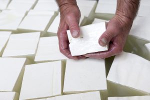 The process of producing tasty traditional white Bulgarian feta cheese at its final stage before packeting. Feta cheese cubes,