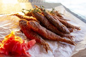 Fried black sea red mullet fish close up