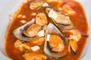 Mussels in shell in tomato sauce - greek mussels saganaki